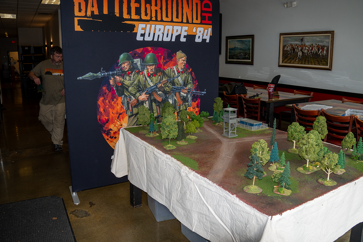 The two tables divided by a screen — the heart of the Double Blind format